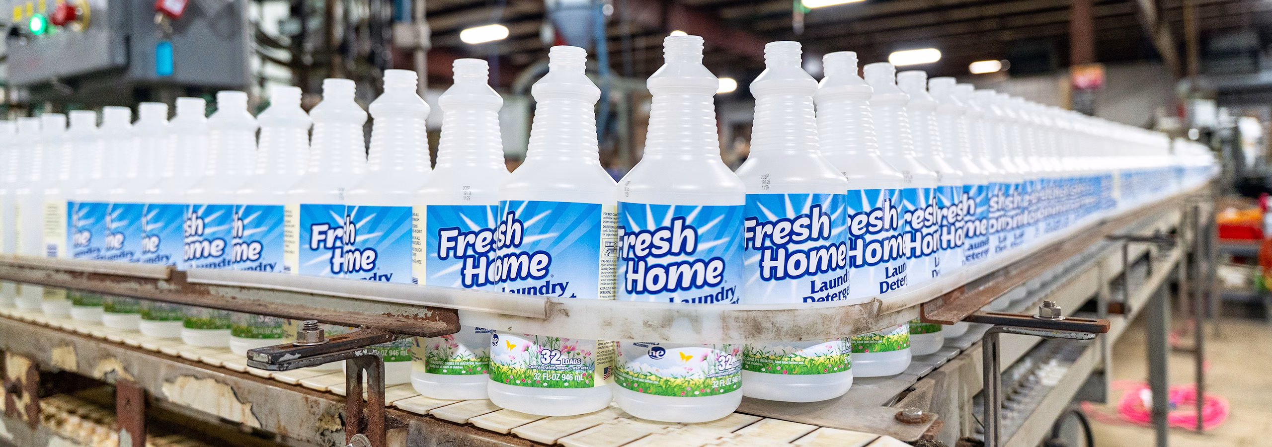 Empty plastic bottles ready to be filled with Fresh Home brand cleanser at Custom Bottling & Packaging.