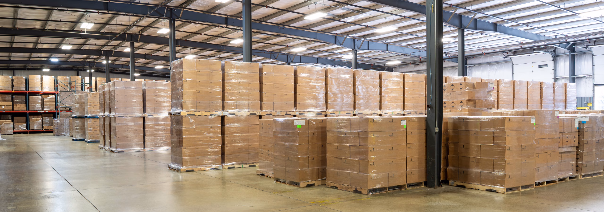 Warehouse with palletized customer products prepared for storage and distribution at Custom Bottling & Packaging.